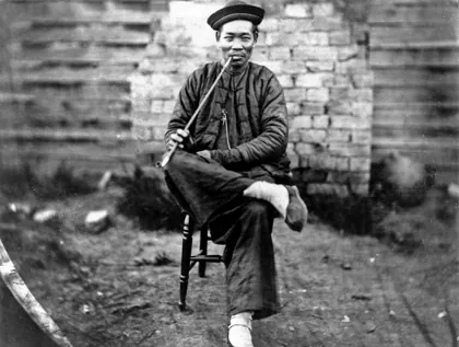 Queensland State Archives 1885 Chinese man in traditional dress seated with opiu, 1870