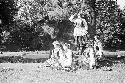 Polish girls in traditional Krzczonów folk costumes resting under a tree, 1938