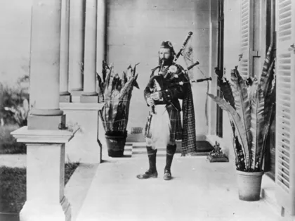StateLibQld 2 42635 Scottish piper on the verandah of Garth House, Wickham Terra, 1876